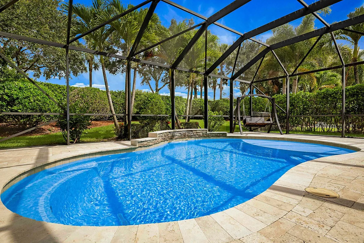 Screened pool and garden of a Parkland, Florida home photographed for a PBP Real Estate listing.