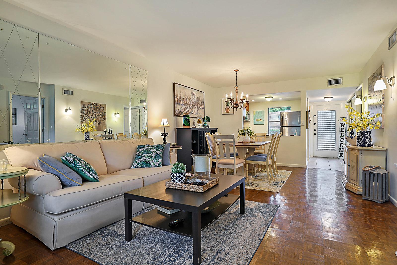 441 NW 76th Avenue #101, Margate, FL 33063 - living room with parquet floors and dining area beyond